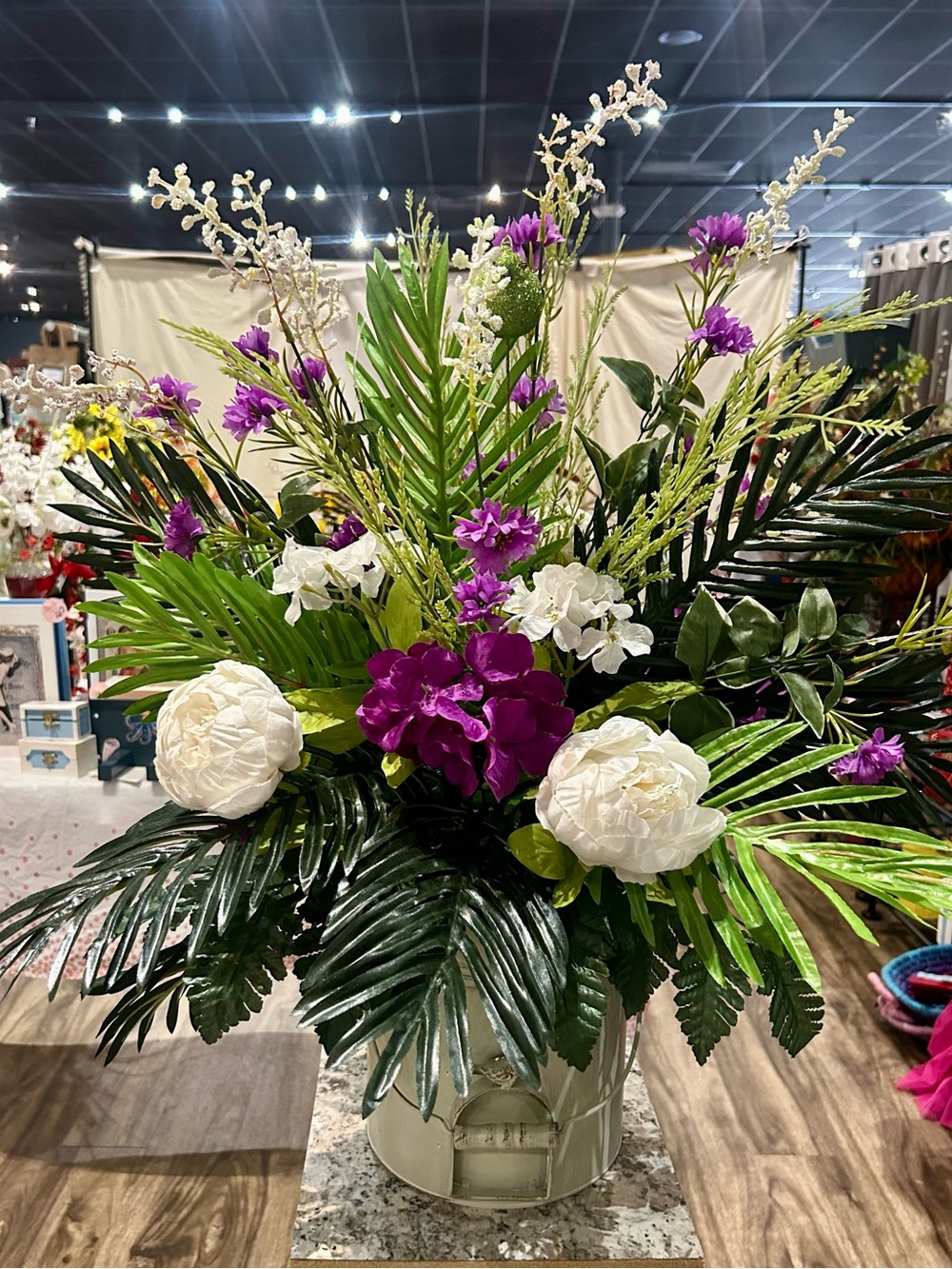 Artificial Purple & White Floral Arrangement in cream tin bird bucket